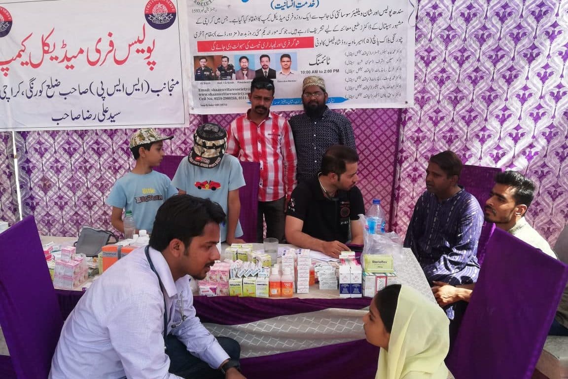 Doctors treating residents at a free medical camp run jointly with Sindh Police.