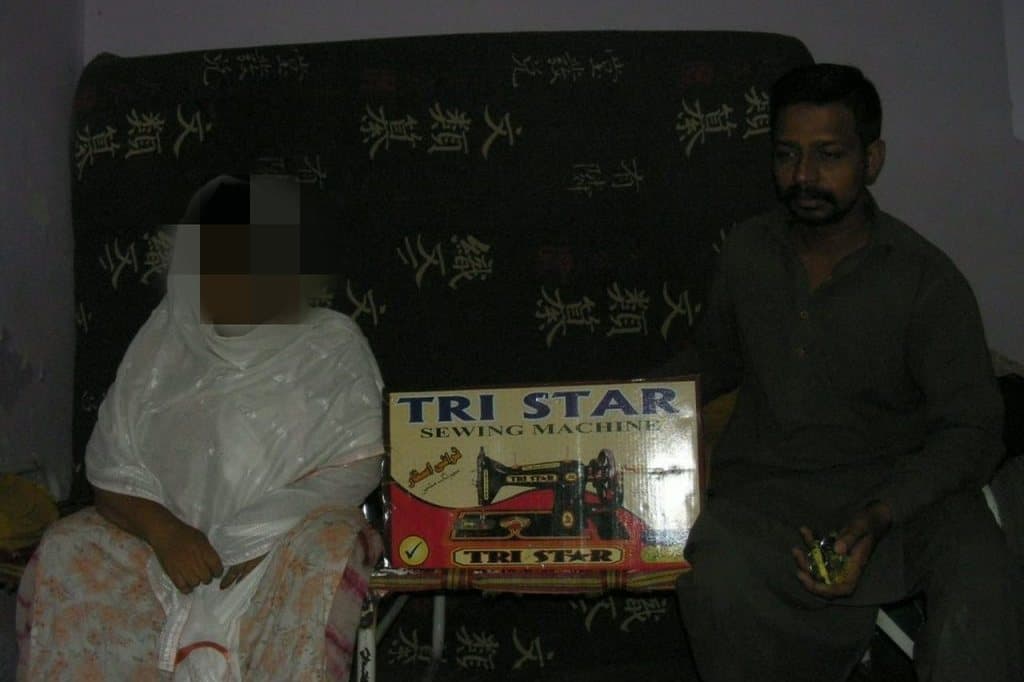 A family receiving a donated sewing machine to support their income.