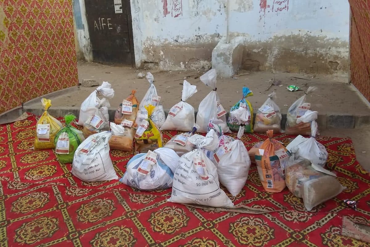 Ration bags of flour, rice and pulses packed and laid out ready for distribution.